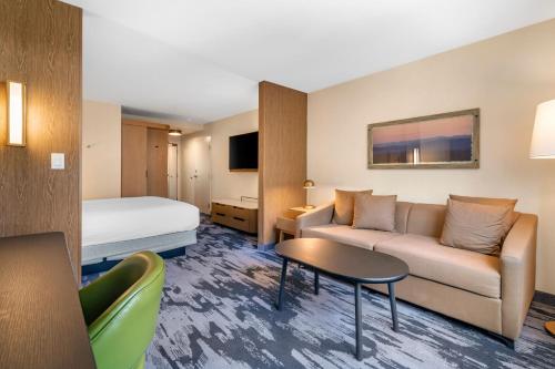 a hotel room with a couch and a bed at Fairfield by Marriott Inn & Suites North Conway in North Conway