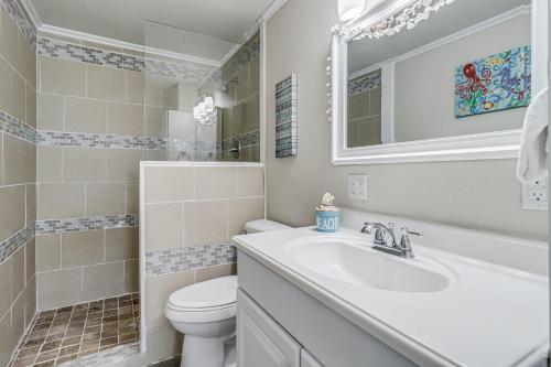 a bathroom with a sink and a toilet and a mirror at Sparrow's Nest in Rockport