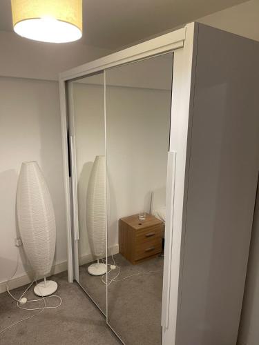 a room with a mirror and two vases on the wall at Modern/Spacious Apartment in Digbeth (5 minute walk from Bullring) in Birmingham
