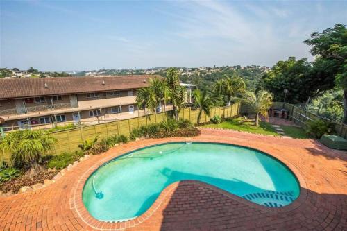 a large blue swimming pool in a yard at Oliphant luxurious in Durban