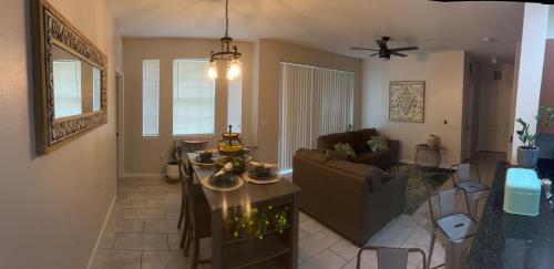 a living room with a couch and a table at LUXURY and VINTAGE space to enjoy your vacation!! in Kissimmee