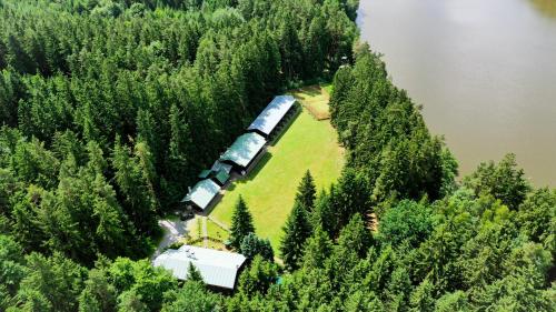 an aerial view of a train traveling through a forest at Komáří Louka in Nová Olešná