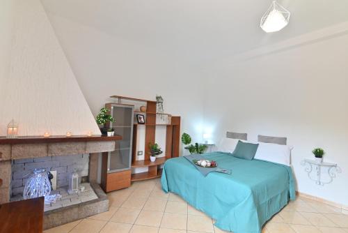 a bedroom with a bed and a fireplace at IzzHome Flamingo in Pula