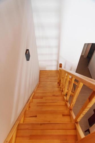 a staircase in a room with wooden floors at KOUL HOUSE in Lefkímmi