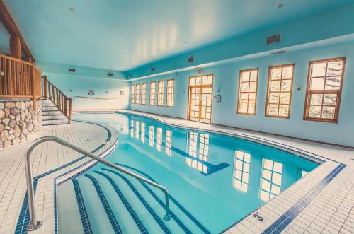 a swimming pool with a blue floor and blue walls at Glacier House Hotel & Resort in Revelstoke