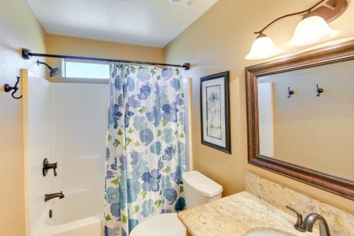 a bathroom with a sink and a toilet and a mirror at Pet-Friendly Arizona Abode Near Beaches and Golfing! in Lake Havasu City
