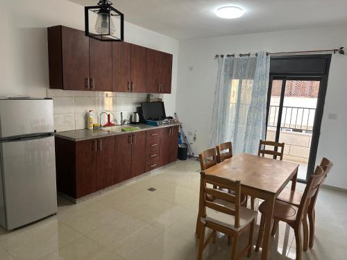 a kitchen with a table and a white refrigerator at Ghanem building 15 in Bethlehem