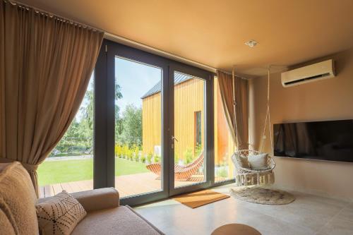 a living room with a large sliding glass door at Casa Bonita Niechorze in Niechorze