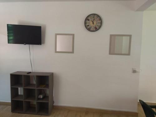 a living room with a tv on a white wall at Garden Suites Comalcalco in Comalcalco