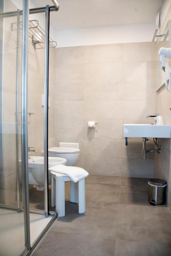 a bathroom with two toilets and a sink at Hotel Solemare - Frontemare - 3 Stelle Superior in Lido di Jesolo