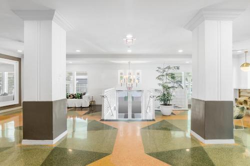a lobby with white columns and a chandelier at Townhouse Hotel, BW Signature Collection in Miami Beach