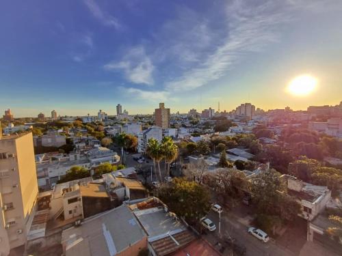 an aerial view of a city with the sun setting at Atardeceres in Resistencia