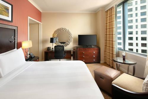 a hotel room with a large bed and a television at Milwaukee Marriott Downtown in Milwaukee