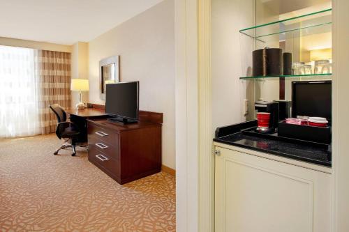 a hotel room with a desk and a television at Milwaukee Marriott Downtown in Milwaukee