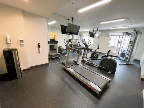 a gym with a treadmill and a flat screen tv at Comfort Inn & Suites Mundelein-Vernon Hills in Mundelein