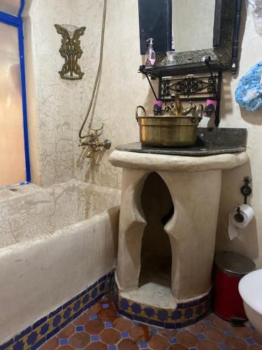 a bathroom with a bath tub and a sink at Riad Azurite in Chefchaouene