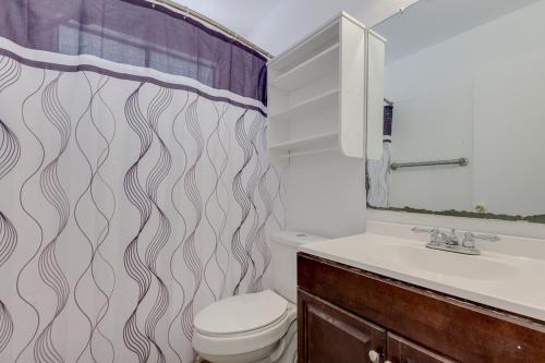 a bathroom with a toilet and a sink and a shower curtain at Shared living NOT A HOTEL in Phoenix