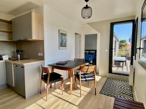 une cuisine et une salle à manger avec une table et des chaises dans l'établissement Magnifique T2 neuf, proche gare, parking facile, à Vannes