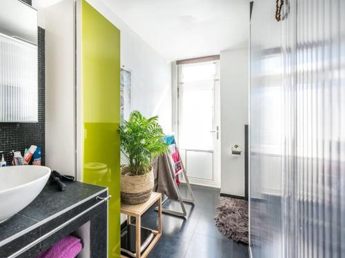 a bathroom with a sink and a mirror at Casa Julie in De Panne