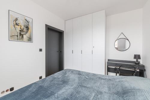 a bedroom with a bed and a mirror and a desk at Apartament w Dolinie Sanu in Lesko