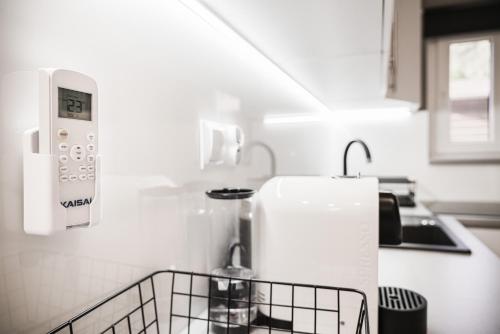 a kitchen with a counter with a sink and a microwave at Sławica Inn domek letniskowy nad jeziorem in Sławica