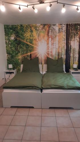 a bed in a room with a wall mural at Ferienwohnung Am Kurpark in Bad Camberg