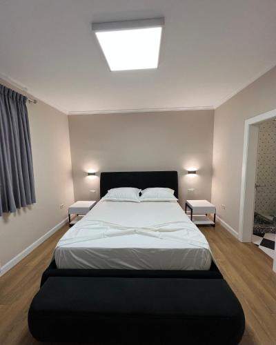 a bedroom with a large bed and a skylight at Vila 90 Boutique Hotel in Tirana