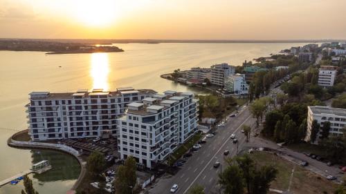 an aerial view of a city with a river and buildings at Blue Luxury Apartment Lake On in Mamaia