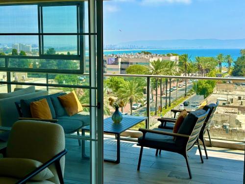 a living room with a view of the ocean at Suite In White in Acre