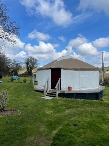 a large tent in a field of grass at The Yurts at Burnt House Farm in Newport