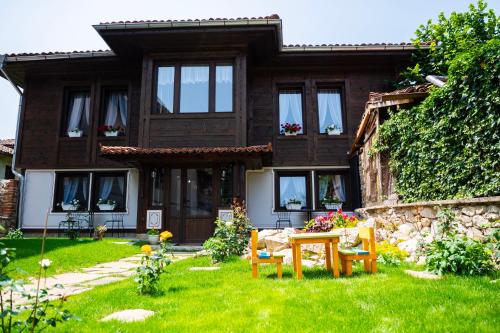 a house with a garden in front of it at Къща ЕТНО in Koprivshtitsa