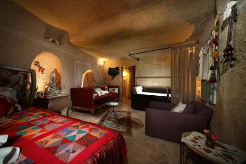a bedroom with a bed and a living room at Pigeon Hotel Cappadocia in Uchisar