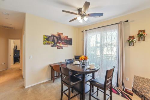 a dining room with a table and chairs and a ceiling fan at Modern Moreno Valley Oasis with Private Patio in Moreno Valley