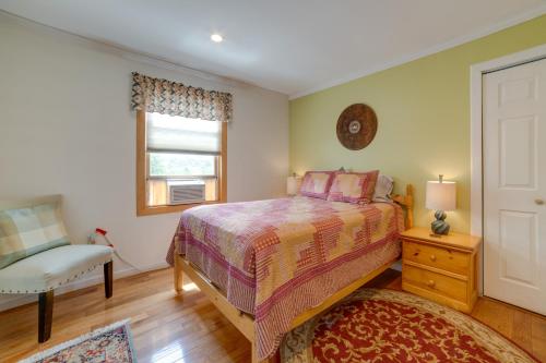 a bedroom with a bed and a chair and a window at Lakeside Gem Hot Tub and Game Room in Hancock in Deposit