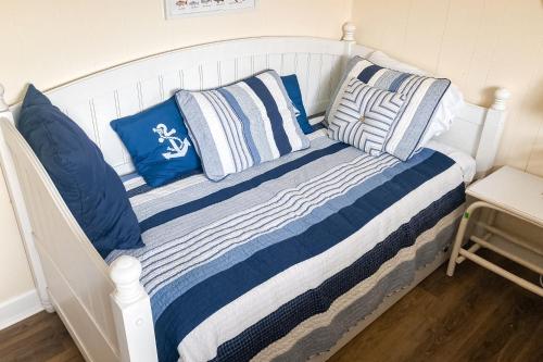 uma cama com almofadas azuis e brancas em Southwinds C8 em Atlantic Beach