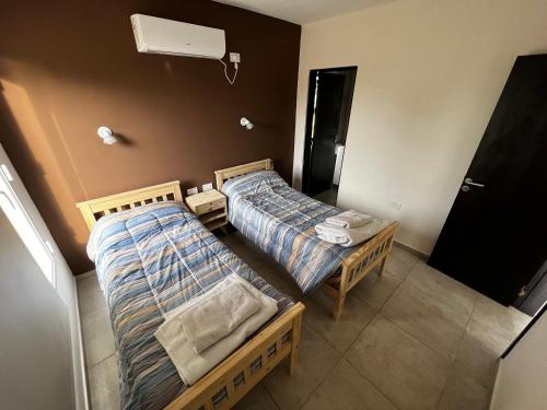 - une vue de tête sur deux lits dans une chambre dans l'établissement DEPARTAMENTOS DEL GOLF, à Macachín