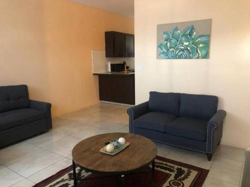 a living room with a couch and a table at Paradise Haven in Nassau