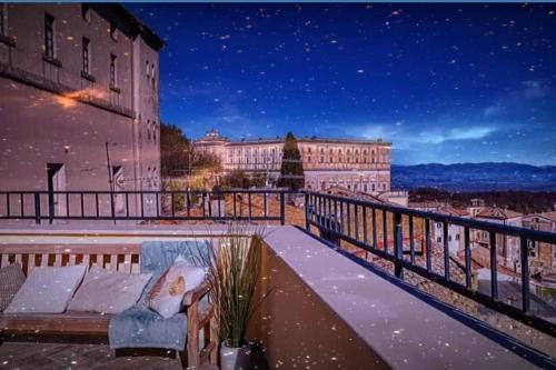 a couch sitting on top of a balcony at night at Casa Checca e Casa Maria appartamenti per vacanze in Caprarola