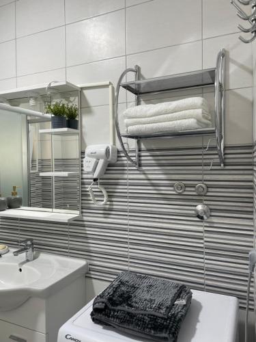 a bathroom with a sink and a mirror and towels at Villa Sunshine in Bar