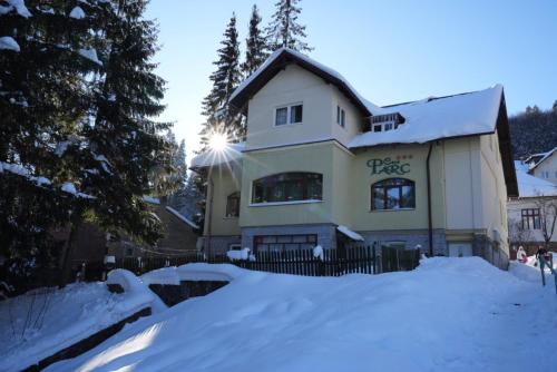 a house with snow in front of it at Casa Parc in Predeal