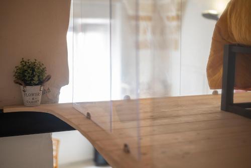 a glass table with a potted plant on top of it at Asmara exclusive "Loft industrial" in Brindisi