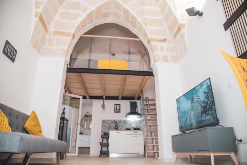 a living room with an archway and a couch at Asmara exclusive "Loft industrial" in Brindisi