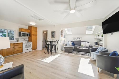 a living room with a couch and a table at Pet-Friendly Newman Lake Cottage with Beach Access! in Post Falls
