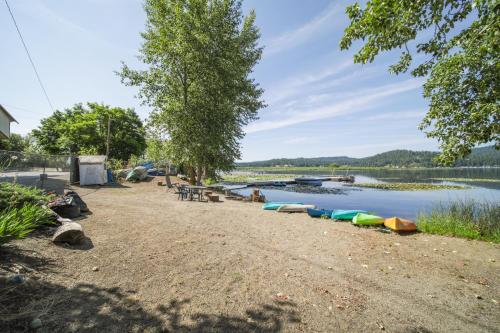 a row of boats on the shore of a lake at Pet-Friendly Newman Lake Cottage with Beach Access! in Post Falls