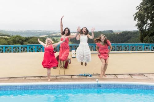 a group of women jumping into a swimming pool at Beaford Country House in Winkleigh