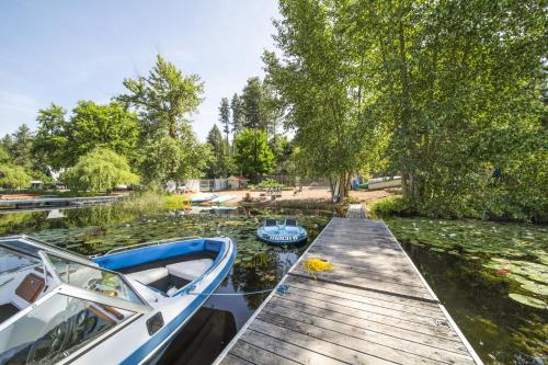 a dock with two boats sitting on the water at Pet-Friendly Newman Lake Cottage with Beach Access! in Post Falls