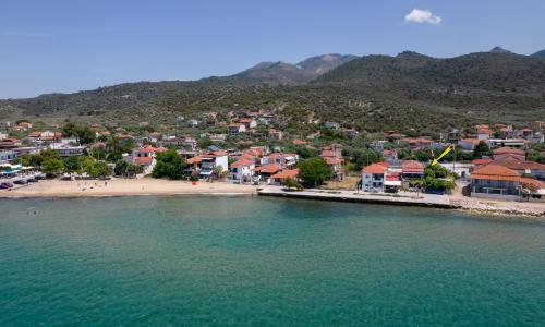 an aerial view of a beach with houses and the water at Golden Sunset Beach Apartment in Skala Kallirakhis