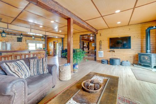 a living room with a couch and a stove at Lakeside Gem Hot Tub and Game Room in Hancock in Deposit