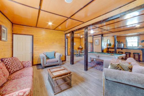 a living room with a couch and a pool table at Lakeside Gem Hot Tub and Game Room in Hancock in Deposit