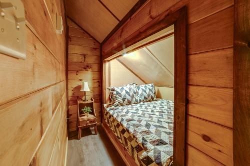 a bedroom in a log cabin with a bed at Lakeside Gem Hot Tub and Game Room in Hancock in Deposit